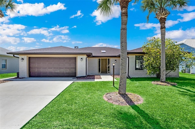 ranch-style home featuring a garage and a front lawn