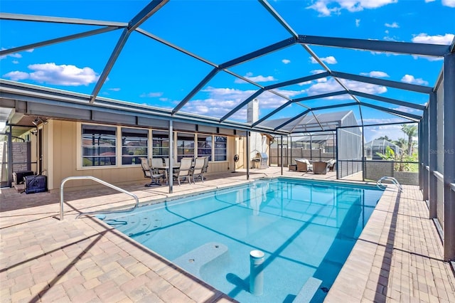 view of swimming pool featuring a patio area and glass enclosure