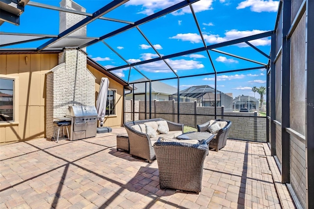 view of patio / terrace featuring area for grilling, an outdoor hangout area, and glass enclosure