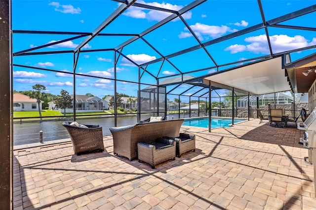 view of swimming pool featuring outdoor lounge area, a patio, glass enclosure, and a water view