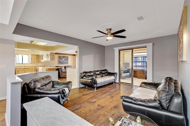 living room with ceiling fan, a healthy amount of sunlight, and wood-type flooring