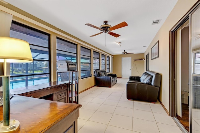 tiled living room featuring ceiling fan