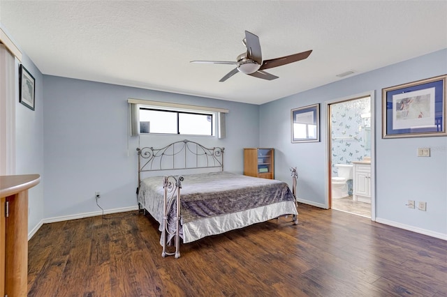 bedroom featuring ceiling fan, dark hardwood / wood-style flooring, ensuite bath, and a textured ceiling