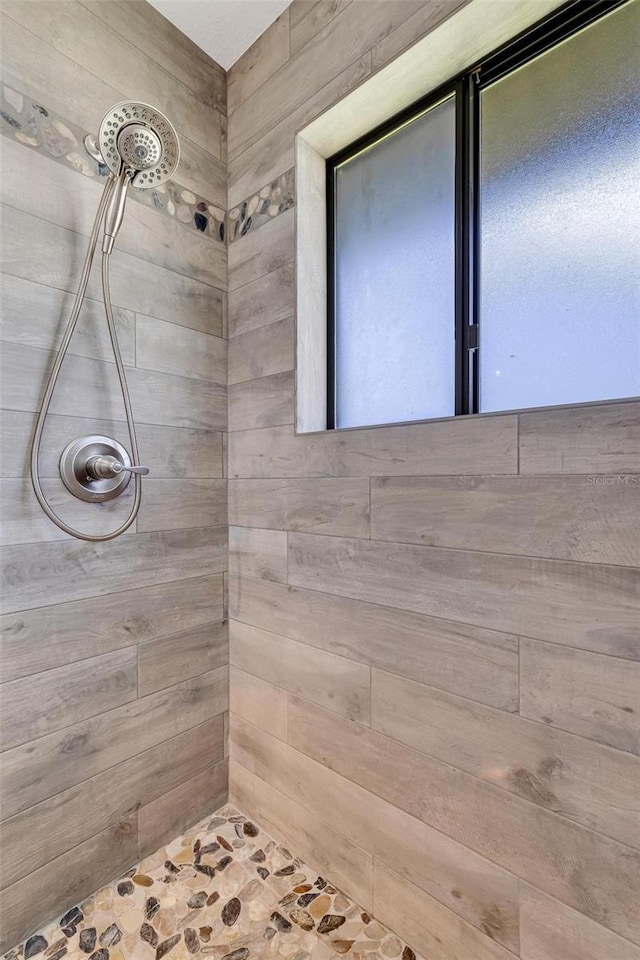 bathroom with tiled shower