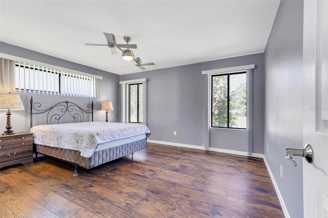 bedroom with dark wood-type flooring and ceiling fan