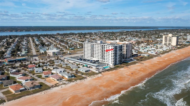 bird's eye view with a water view and a view of the beach