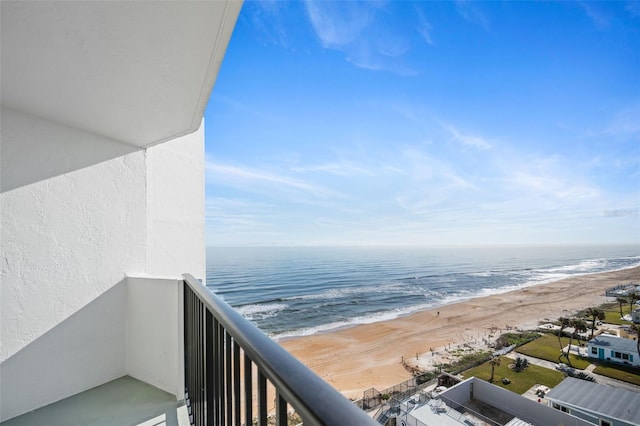 balcony with a water view and a beach view