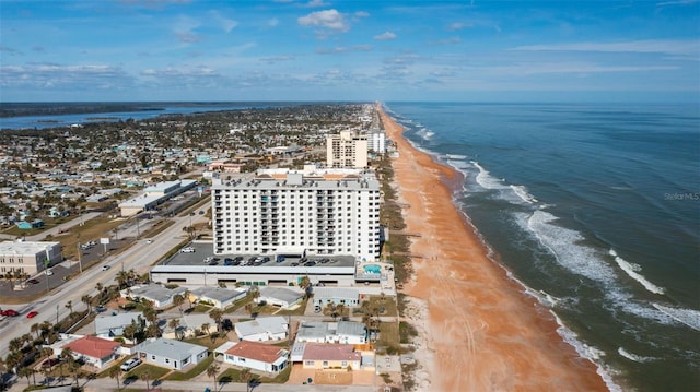 birds eye view of property with a water view and a view of the beach