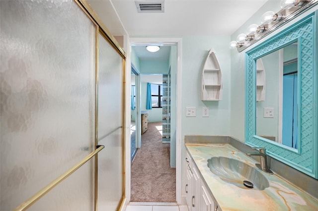 bathroom with vanity, tile patterned flooring, and walk in shower