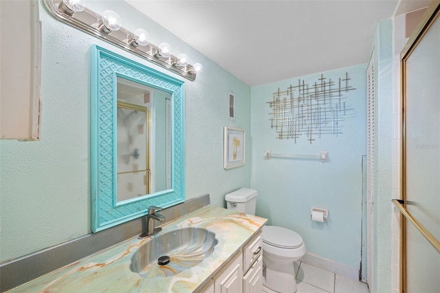 bathroom featuring walk in shower, tile patterned floors, toilet, and vanity