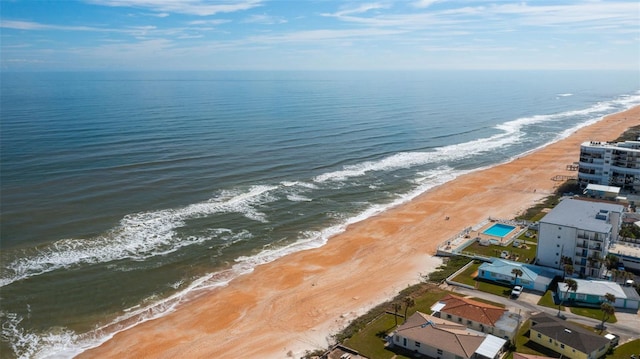 aerial view featuring a water view and a beach view