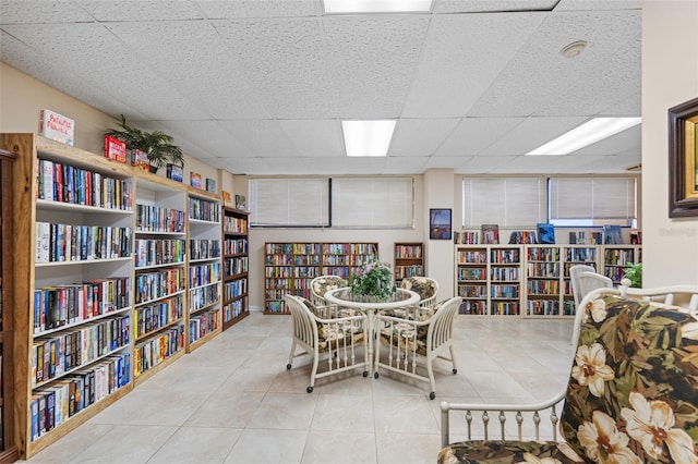 tiled dining room with a drop ceiling