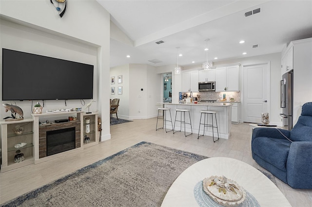 living room featuring vaulted ceiling