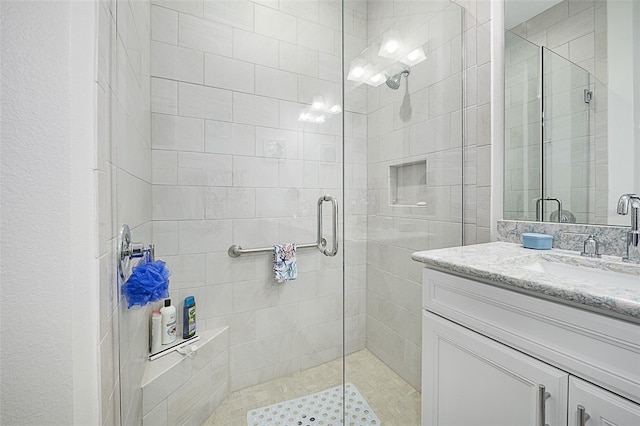 bathroom featuring walk in shower and vanity