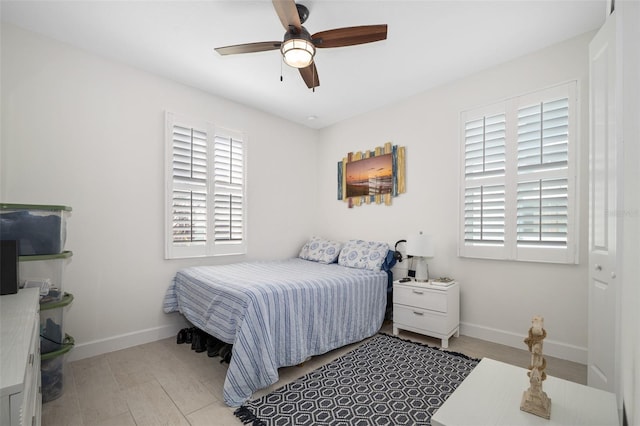 bedroom featuring multiple windows and ceiling fan