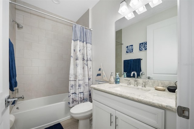 full bathroom with shower / tub combo with curtain, vanity, and toilet