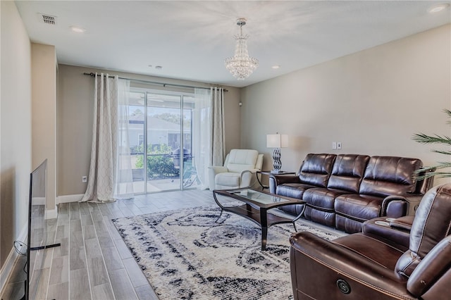 living room featuring wood finished floors, visible vents, baseboards, recessed lighting, and a notable chandelier