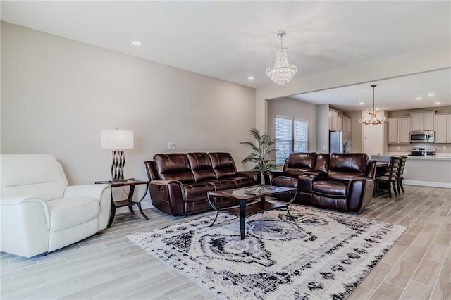 living room with wood finish floors, an inviting chandelier, and recessed lighting