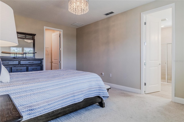 bedroom featuring baseboards, visible vents, light colored carpet, ensuite bath, and a notable chandelier