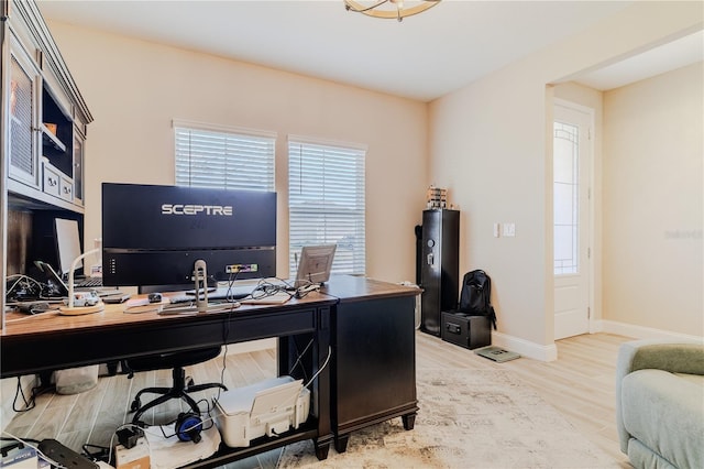 office space with baseboards and wood finished floors