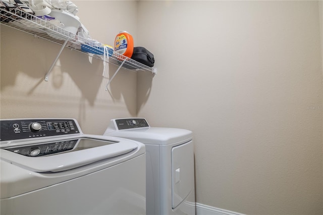 laundry room with laundry area and washing machine and clothes dryer