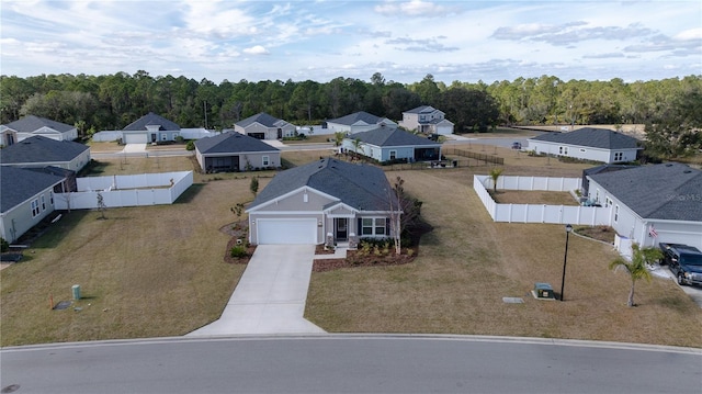 birds eye view of property with a residential view and a forest view