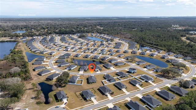 aerial view featuring a water view, a residential view, and a view of trees