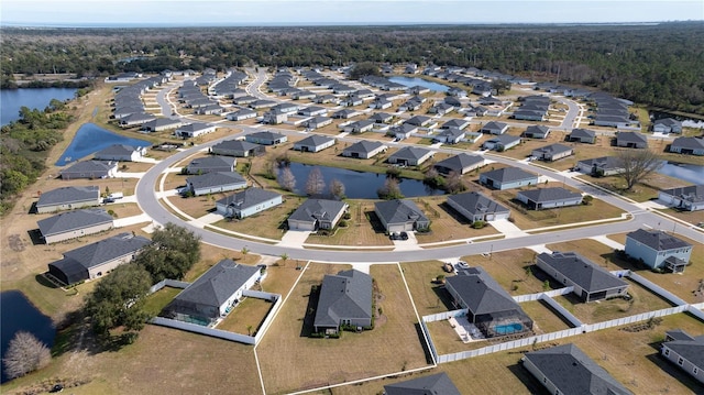 aerial view with a residential view, a water view, and a wooded view