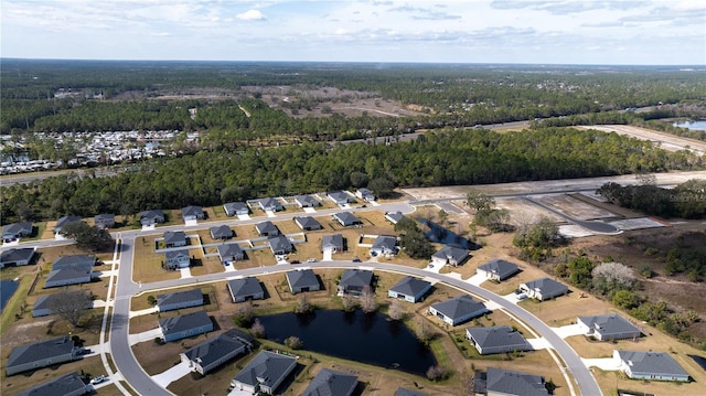 aerial view with a water view and a wooded view