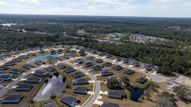 drone / aerial view featuring a water view and a view of trees