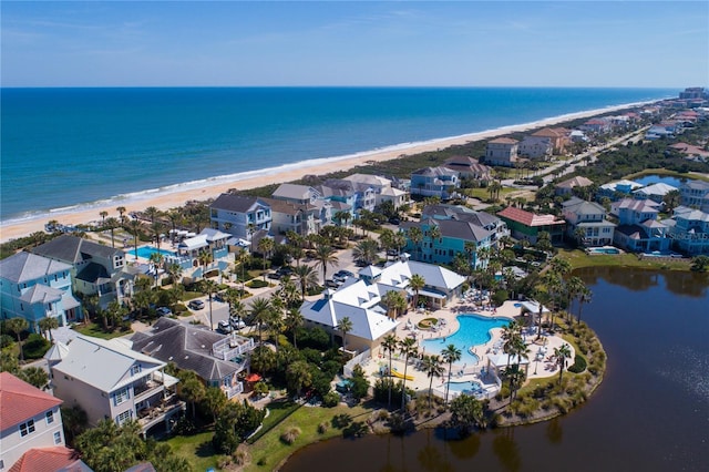 birds eye view of property with a view of the beach and a water view