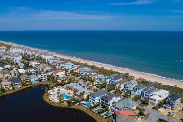 birds eye view of property featuring a water view and a view of the beach