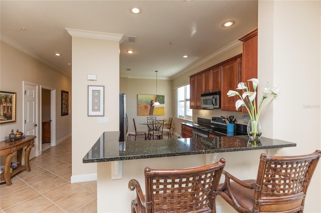 kitchen featuring stainless steel appliances, kitchen peninsula, and dark stone counters