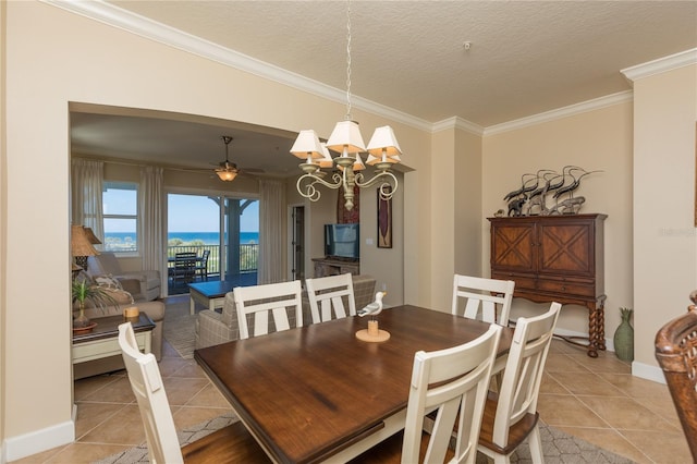 dining space featuring light tile patterned flooring, ornamental molding, and a textured ceiling