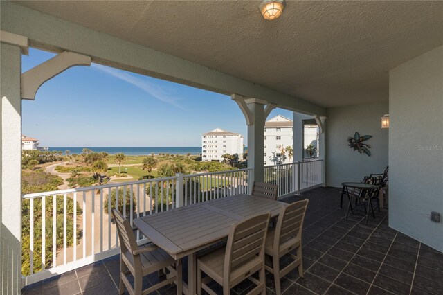 view of patio / terrace with a balcony and a water view