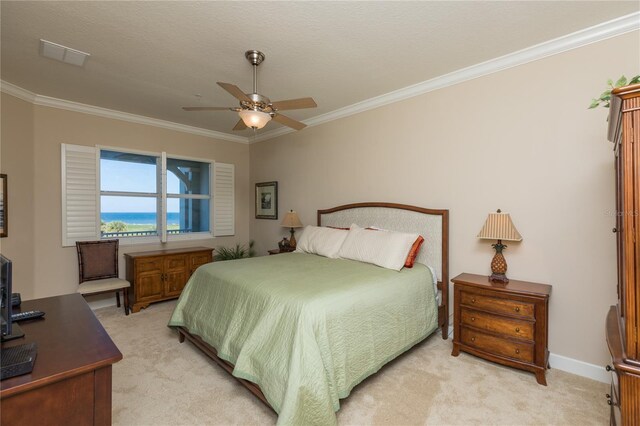 bedroom with crown molding, light colored carpet, and ceiling fan