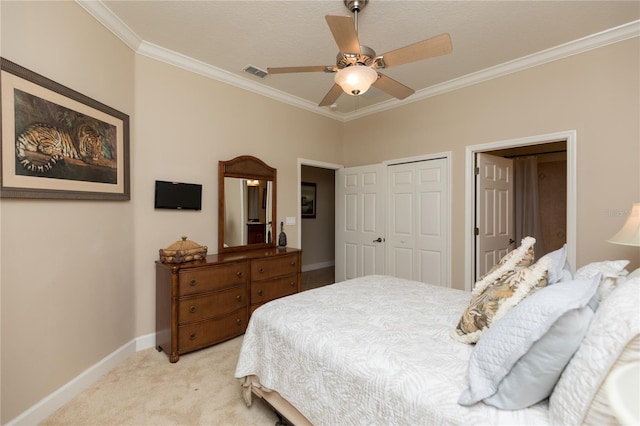 carpeted bedroom featuring crown molding, ceiling fan, and a closet