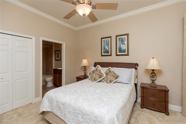 carpeted bedroom with crown molding, ceiling fan, ensuite bath, and a closet