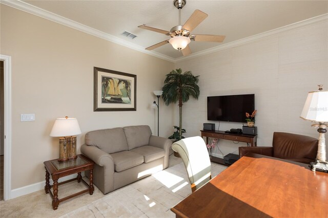 carpeted living room with crown molding and ceiling fan