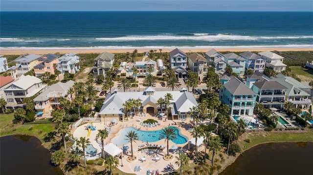 bird's eye view featuring a water view and a beach view