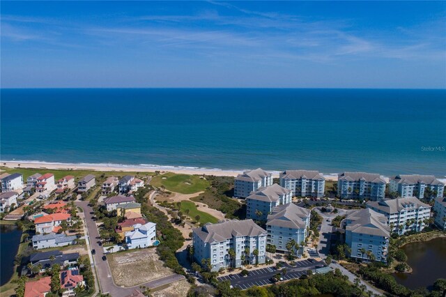 bird's eye view featuring a water view and a view of the beach