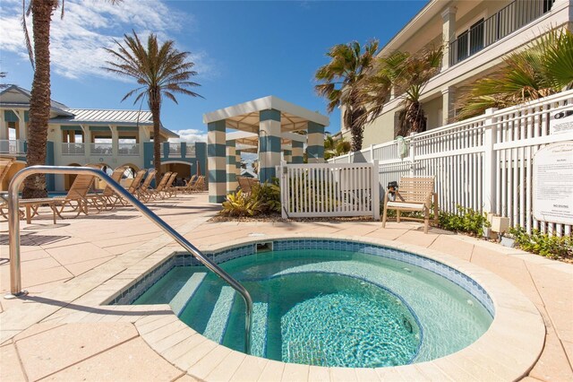 view of swimming pool with a hot tub