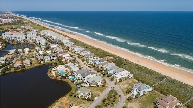 aerial view featuring a view of the beach and a water view