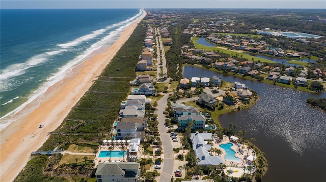 birds eye view of property with a beach view and a water view