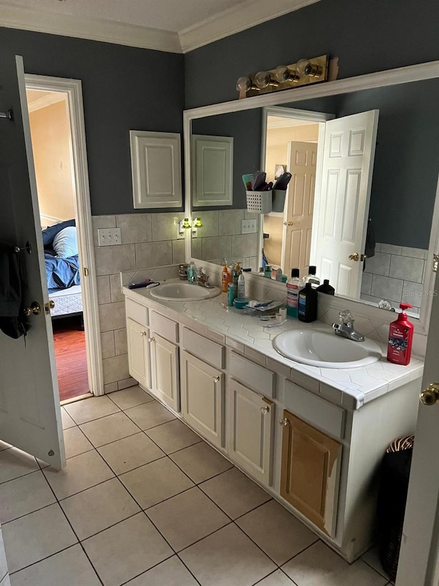 bathroom with ornamental molding, tile walls, vanity, and tile patterned floors