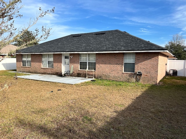 rear view of property featuring a lawn, a patio, and central air condition unit