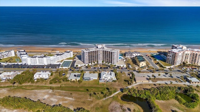 birds eye view of property featuring a water view and a beach view