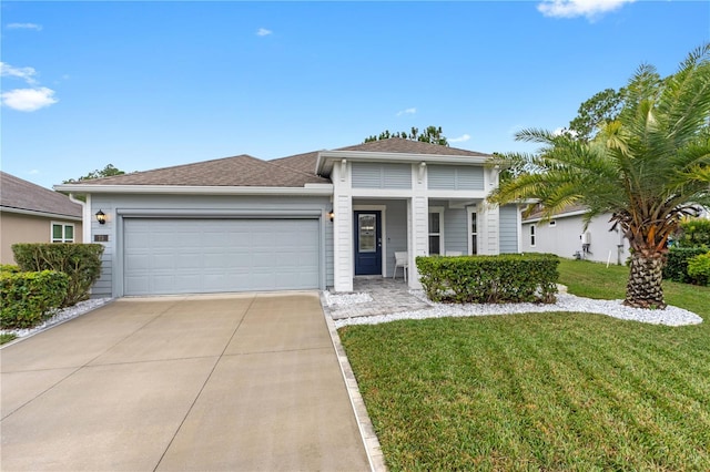 view of front of property featuring a garage and a front yard