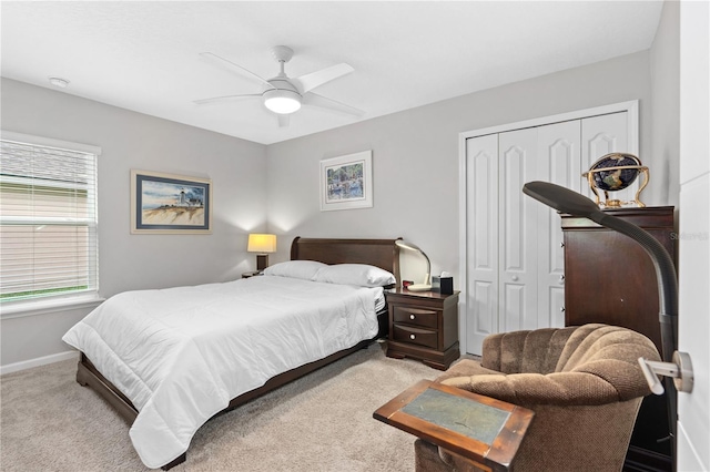 carpeted bedroom featuring ceiling fan and a closet