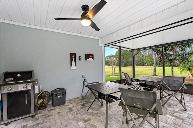 sunroom featuring ceiling fan